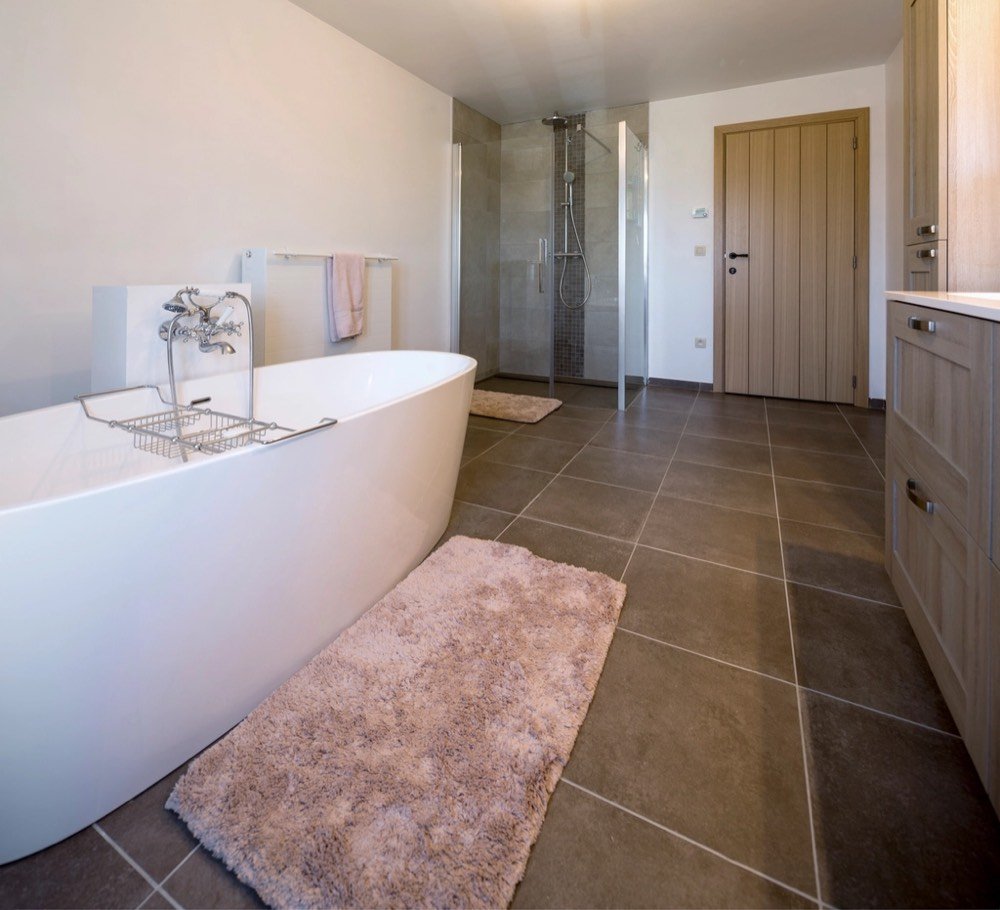Renovated bathroom with bathtub and shower