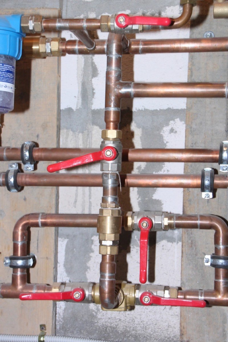 Copper water pipes with red valves